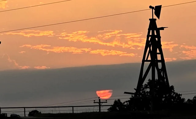 The sun going down past the windmill